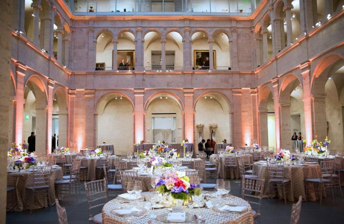 A low-angle view of the Calderwood Courtyard with tables and lighting set for an elegant event.